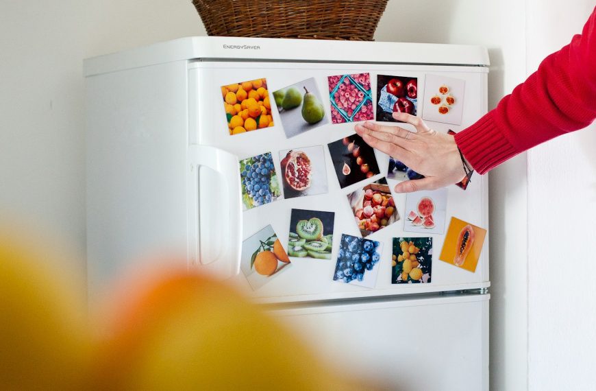 a refrigerator with pictures of fruits and vegetables on it