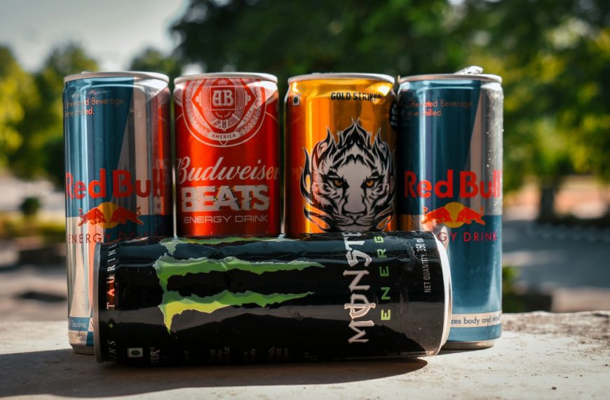 a group of four cans of soda sitting next to each other