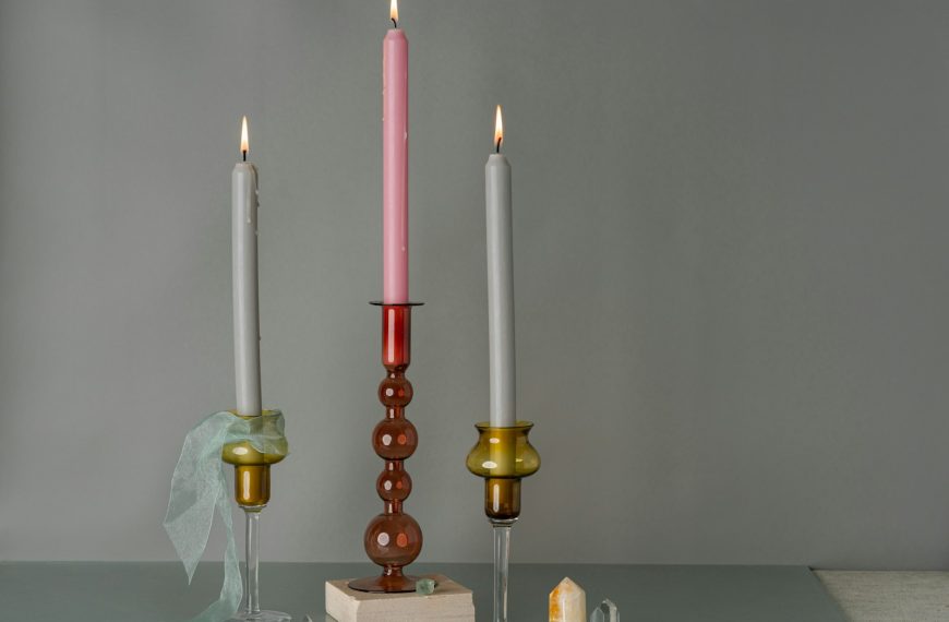 A couple of candles sitting on top of a table