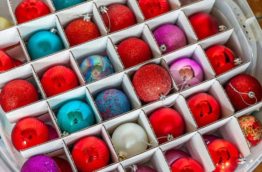 Vibrant Christmas ornaments in storage box from top view, perfect for festive decoration.