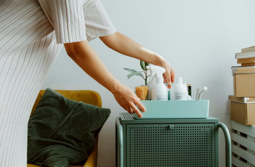 A woman organizes self-care products in a stylish room, embodying minimalism and tranquility.