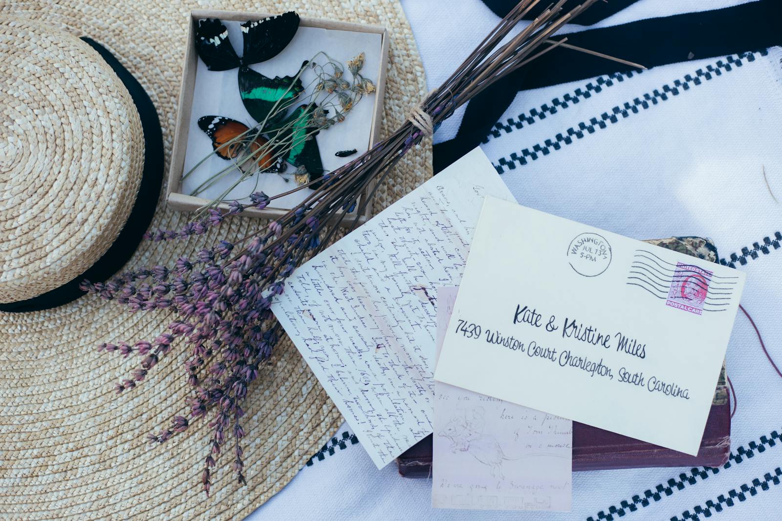 Nostalgic composition featuring lavender, a straw hat, and handwritten letters.