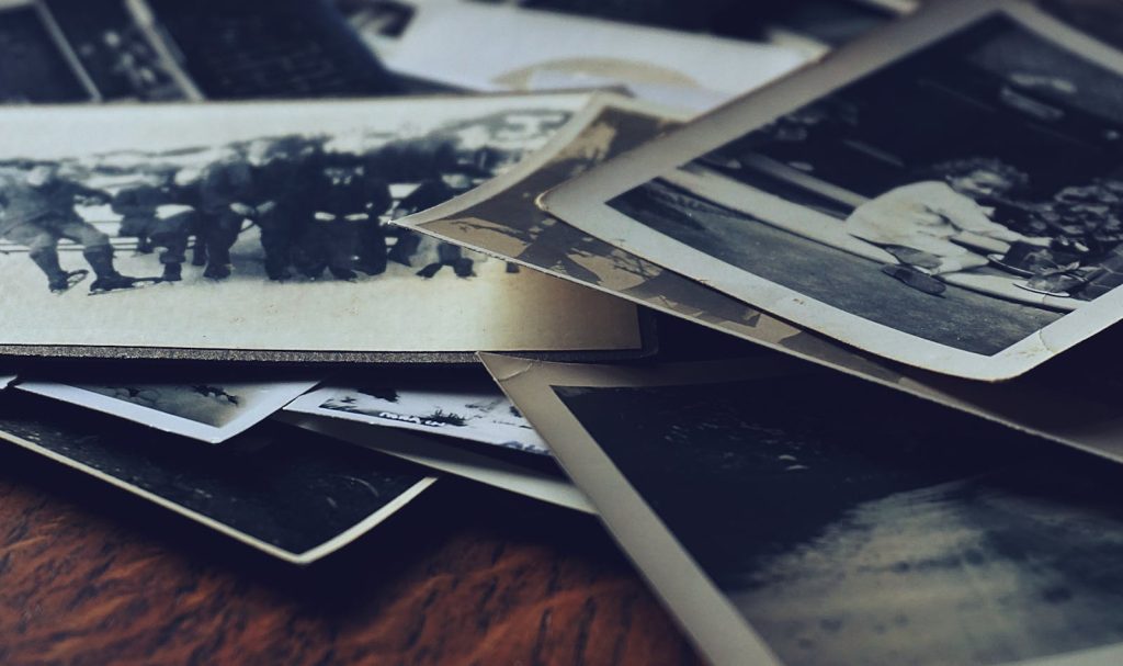 A stack of classic black and white photographs showcasing family memories and history.