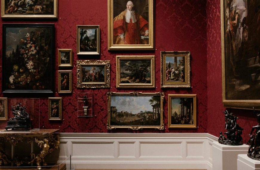 Discover classic art in an elegantly designed gallery space with red ornate walls.