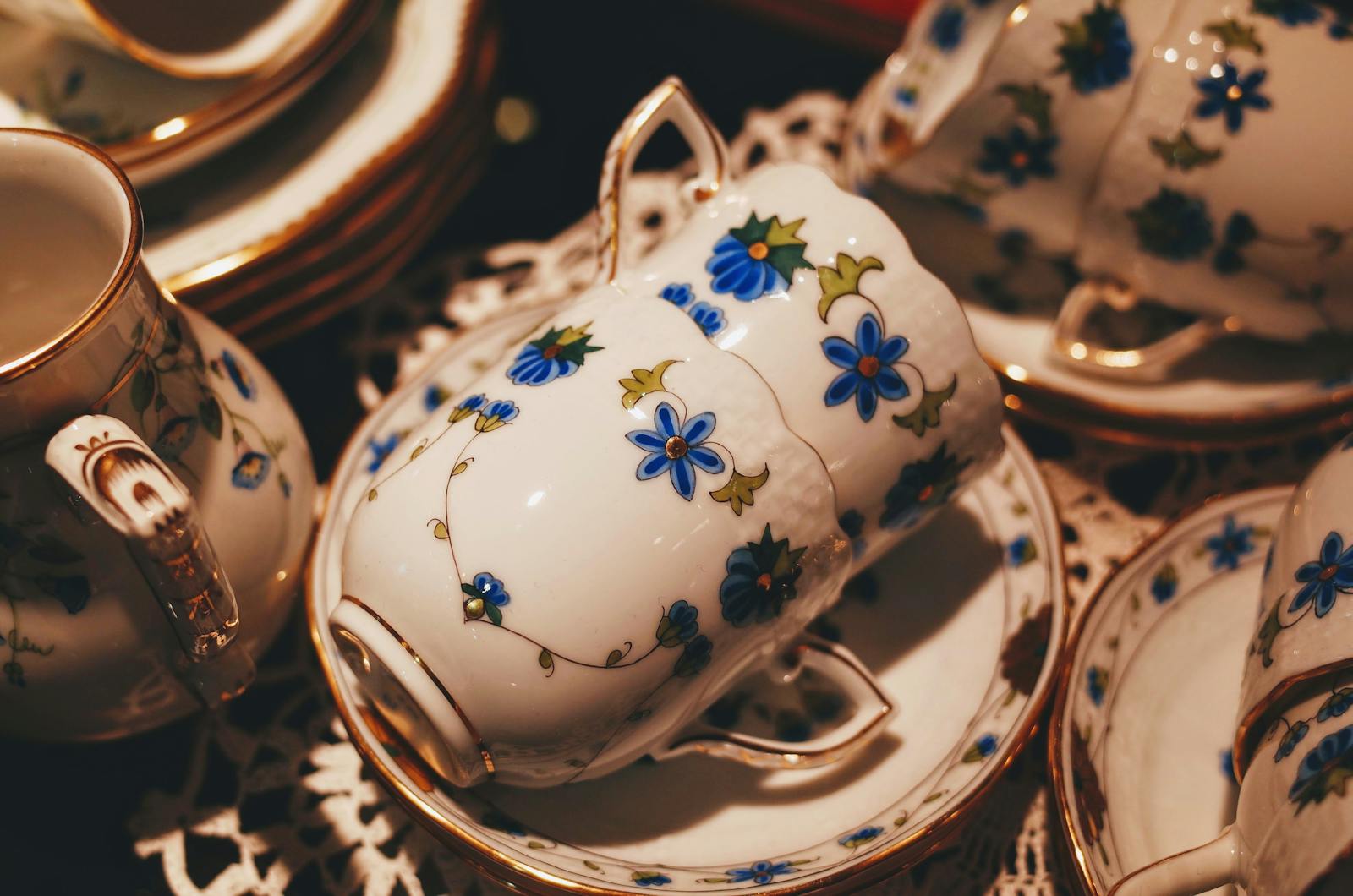 A beautifully detailed floral porcelain tea set with gold trim, perfect for elegant gatherings.