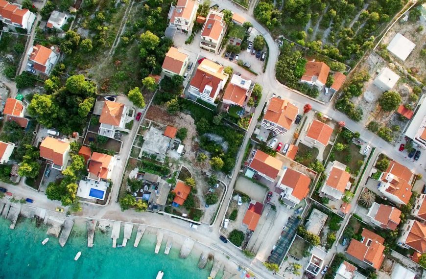 A scenic aerial shot of a seaside town in Croatia featuring rooftops and clear blue waters.