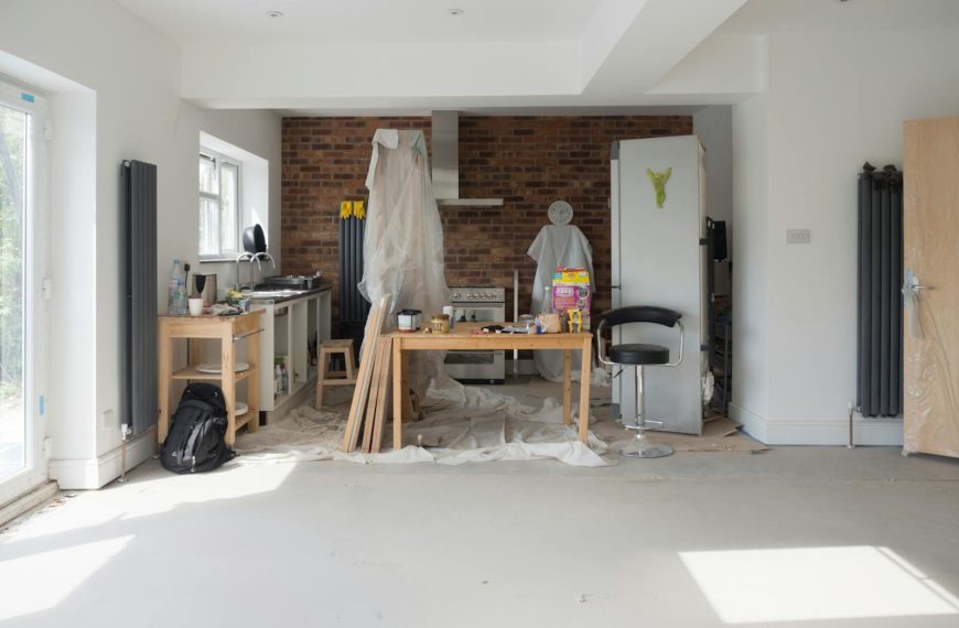 Bright kitchen extension showing renovation work with tools and materials.