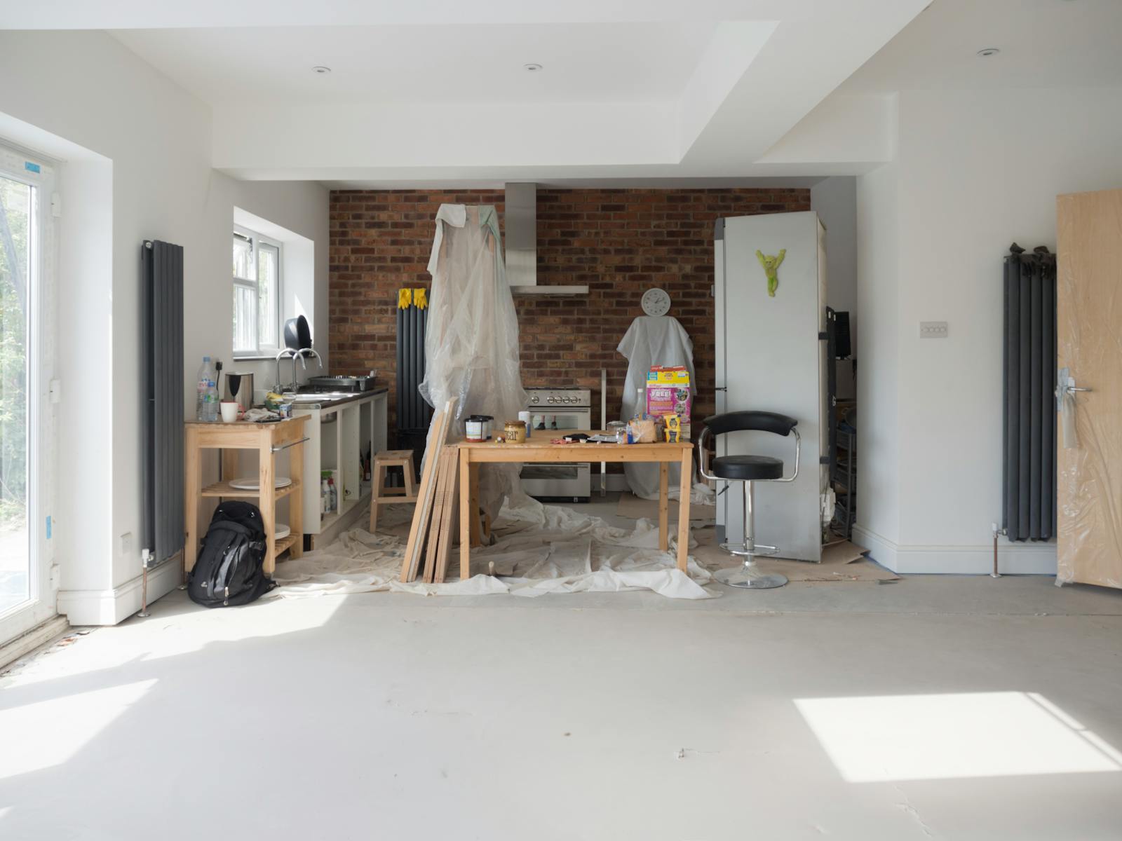 Bright kitchen extension showing renovation work with tools and materials.