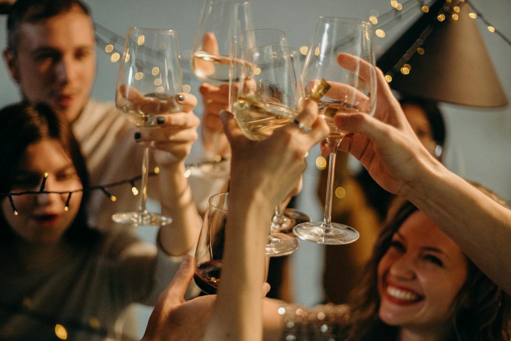 A group of friends joyfully toasting with champagne glasses at a festive celebration.