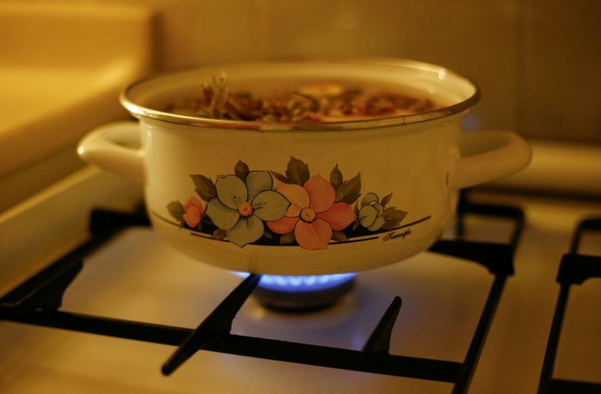 A vintage floral pot simmering on a gas stove, filling the kitchen with warmth.