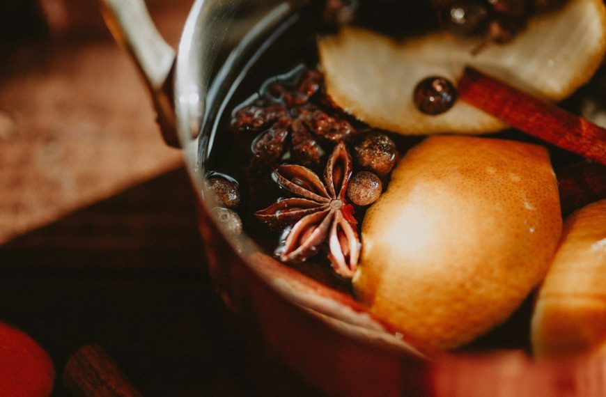 a pot filled with fruit and nuts on top of a table