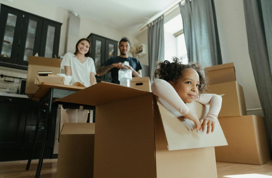 Family enjoys a joyful moment while unpacking boxes in their new kitchen.