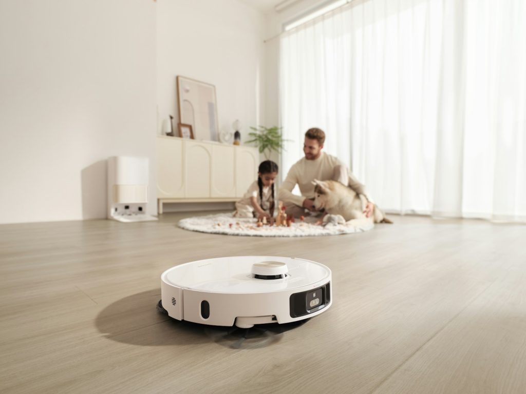 Robot vacuum cleans floor while family relaxes