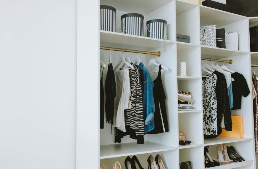 Neatly arranged wardrobe showcasing stylish clothes and shoes indoors.