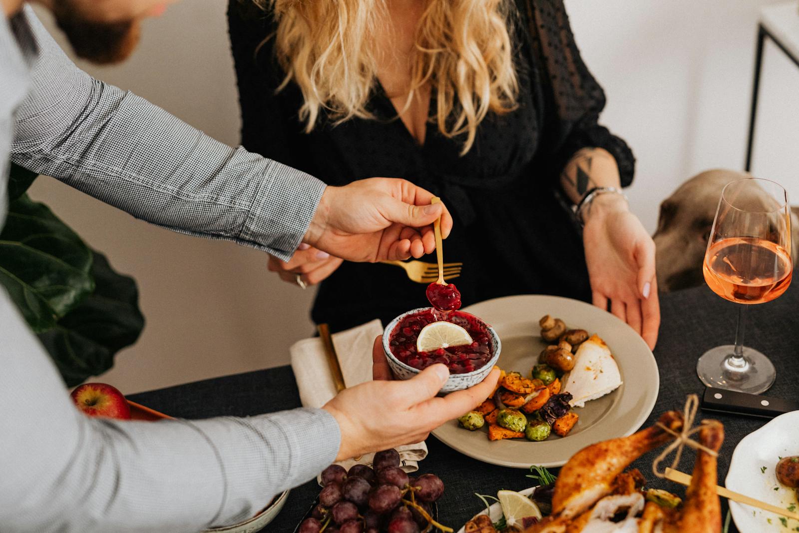 A couple enjoys a sophisticated dinner with gourmet dishes and wine.