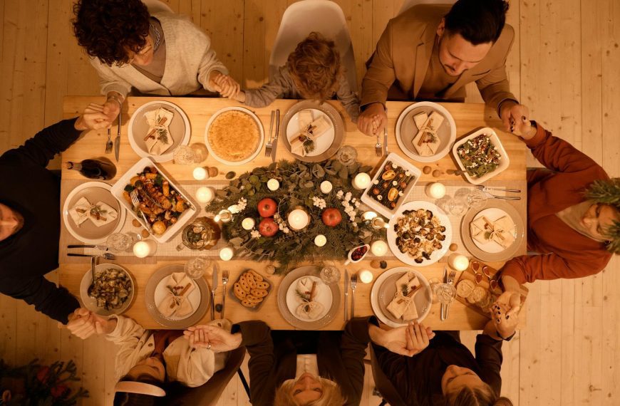 Family gathered around a beautifully set table for a festive Christmas dinner celebration.