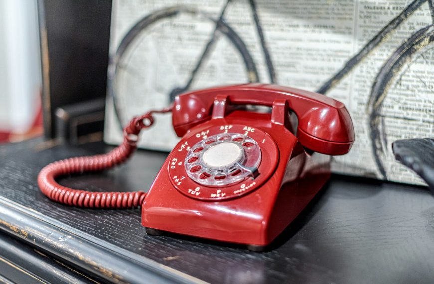 a red telephone sitting on top of a table