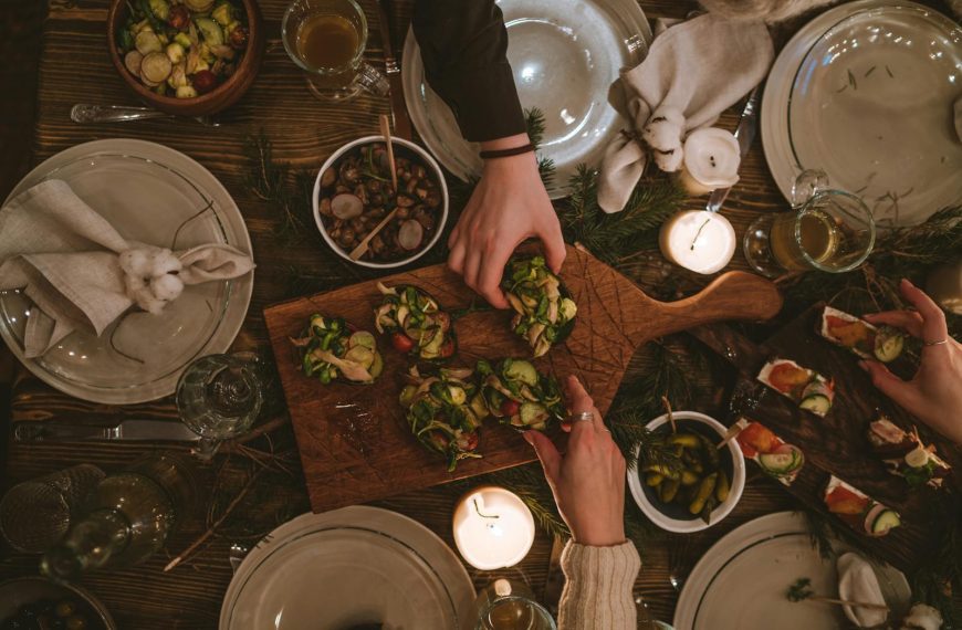 Warm and inviting holiday table with festive decorations and appetizers.