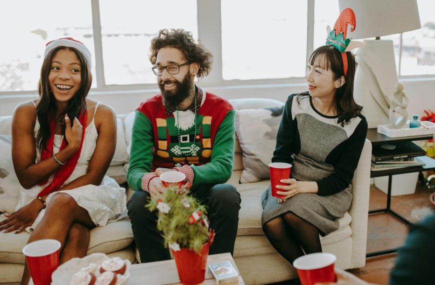 Joyful office celebration with diverse friends enjoying a holiday party indoors.