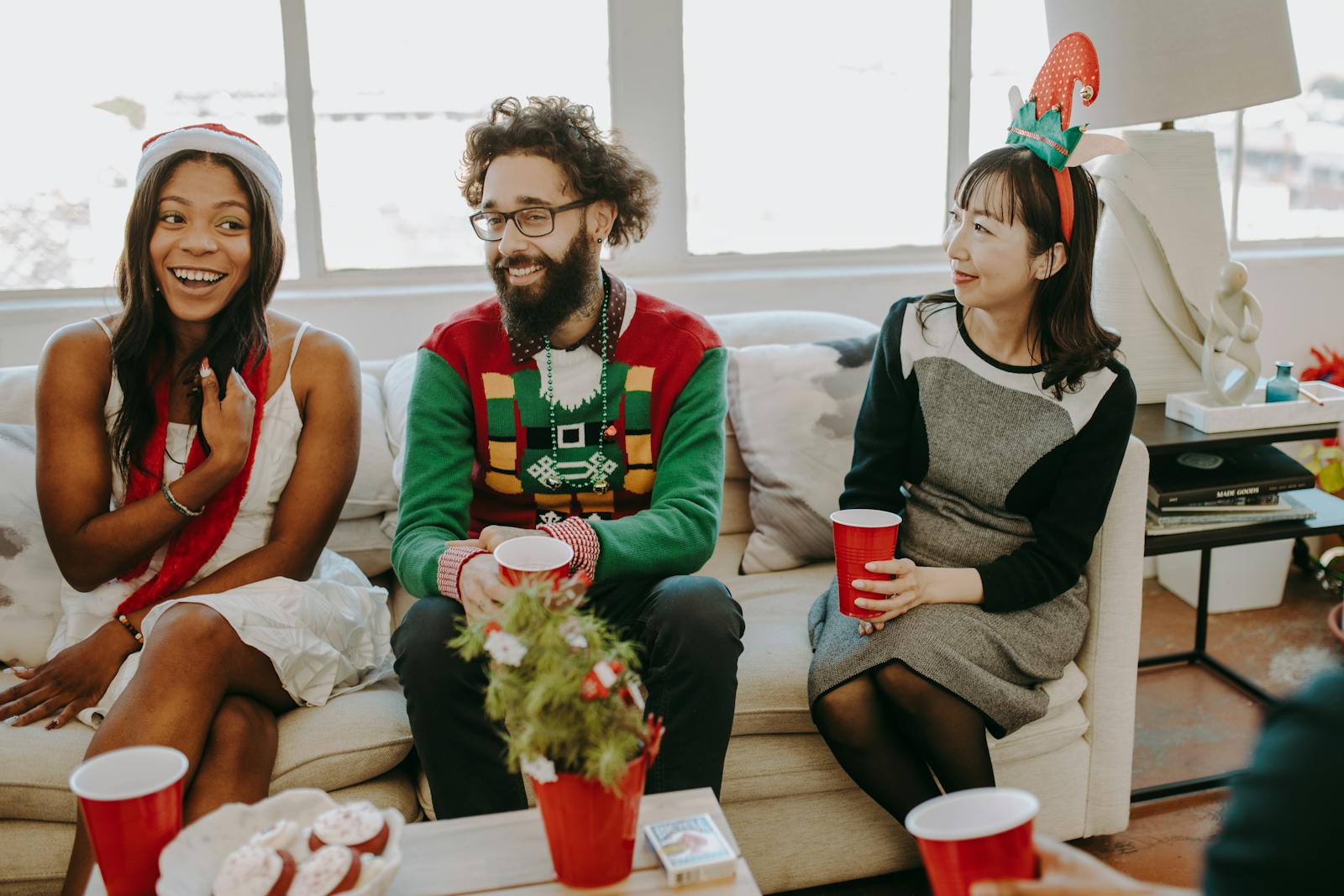 Joyful office celebration with diverse friends enjoying a holiday party indoors.