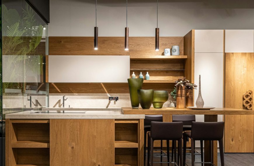 Explore this elegant modern kitchen featuring wooden cabinets and minimalist decor.