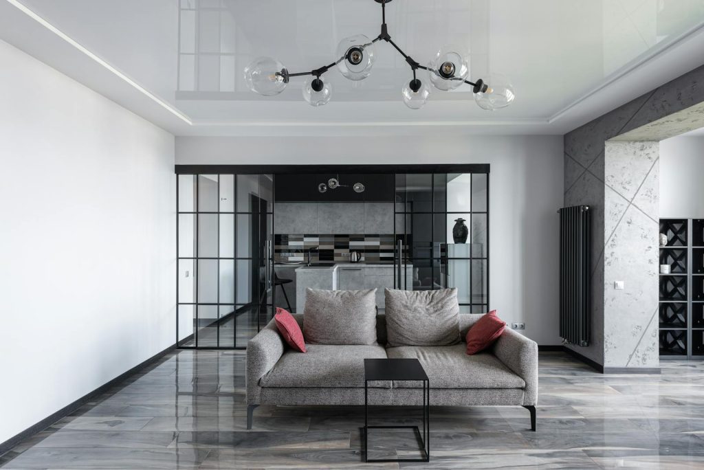 Elegant living room featuring a sleek grey sofa and contemporary design elements.