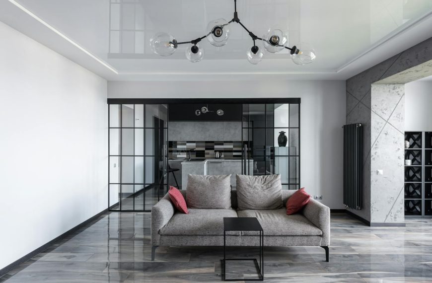 Elegant living room featuring a sleek grey sofa and contemporary design elements.