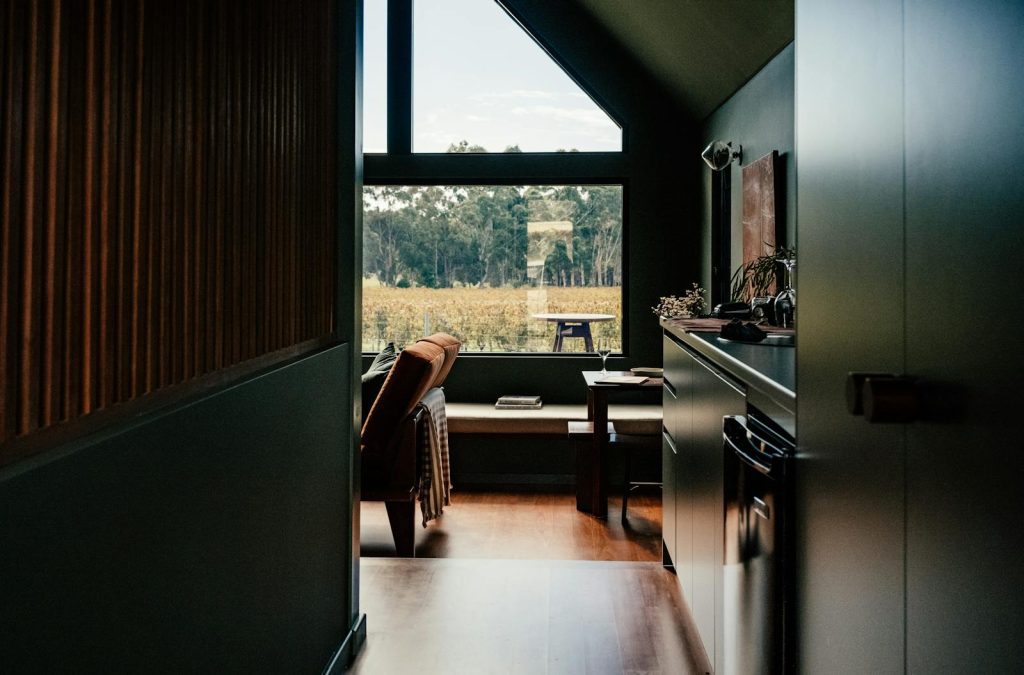 Serene modern interior featuring a large window with a scenic view of nature.