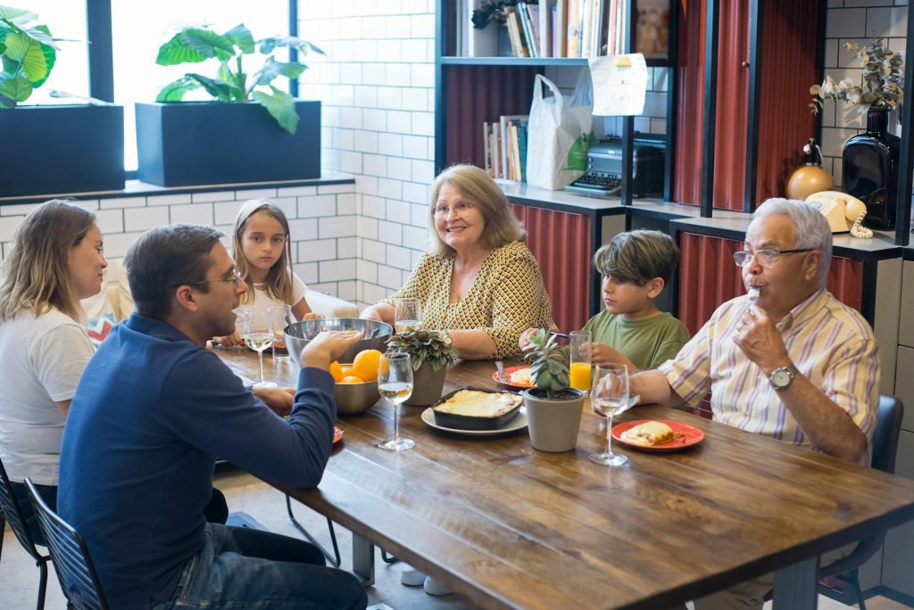 A joyful family dining together indoors, highlighting togetherness and culinary enjoyment.