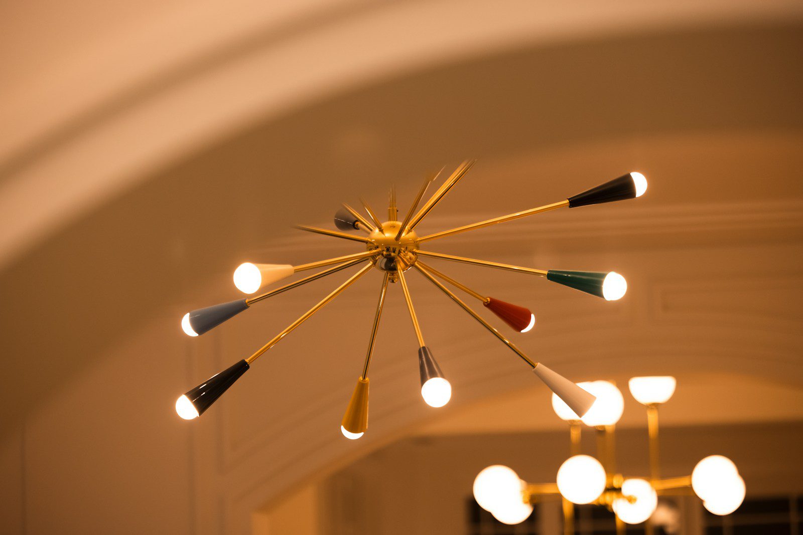 A starburst chandelier with colorful accents.