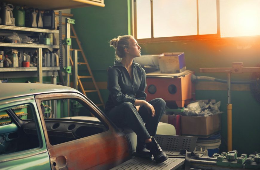 woman sitting on orange vehicle