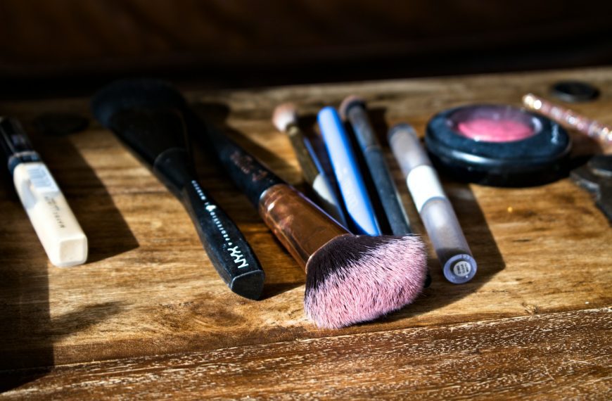 black and brown makeup brush on brown wooden table