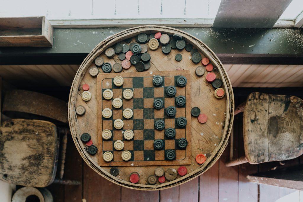 A wooden board game set up on a wall
