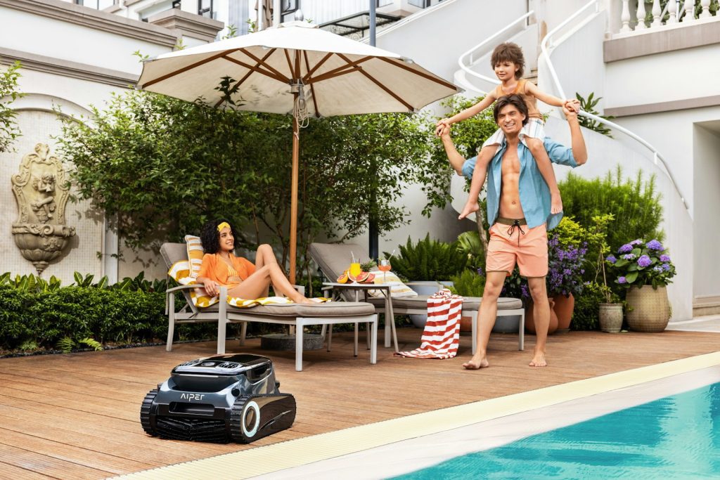 A couple of people standing next to a pool