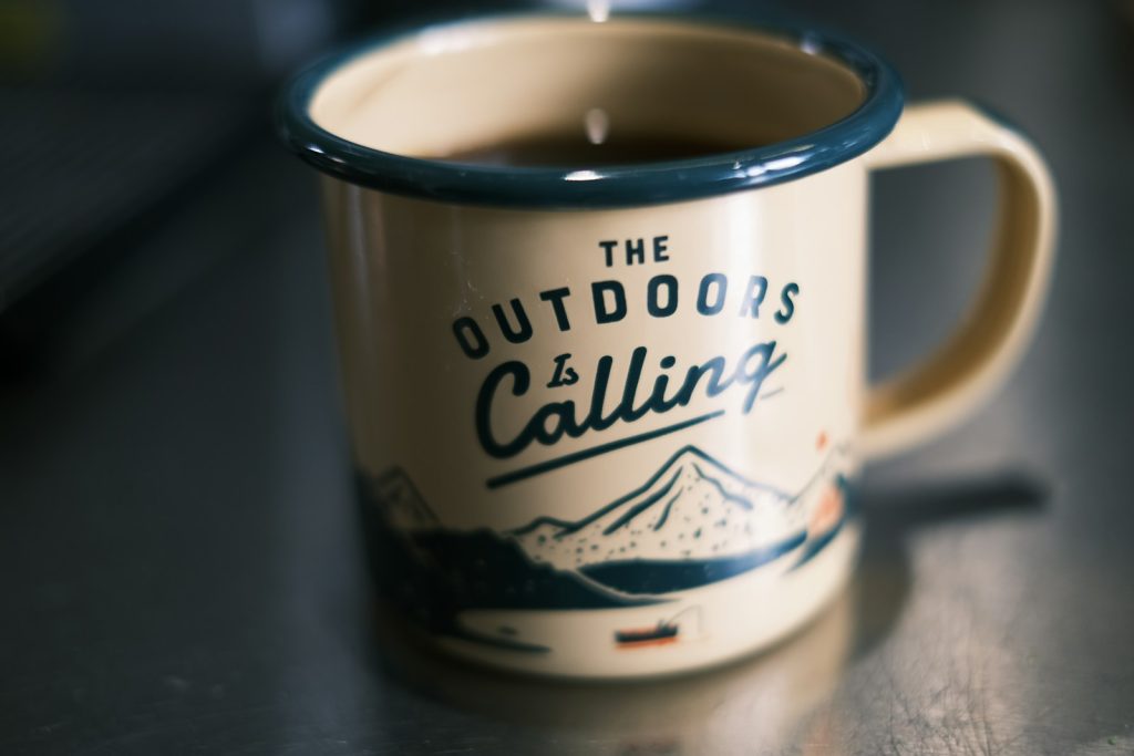 a cup of coffee sitting on top of a table