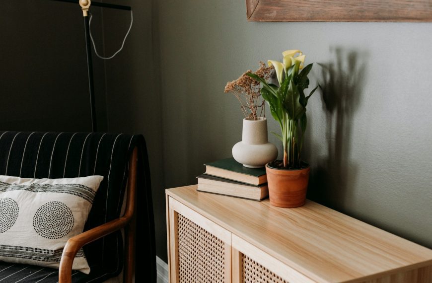 a living room with a couch and a table with a vase of flowers on it