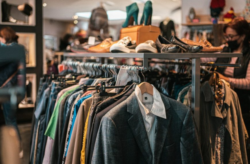 a rack of clothes and shoes in a store
