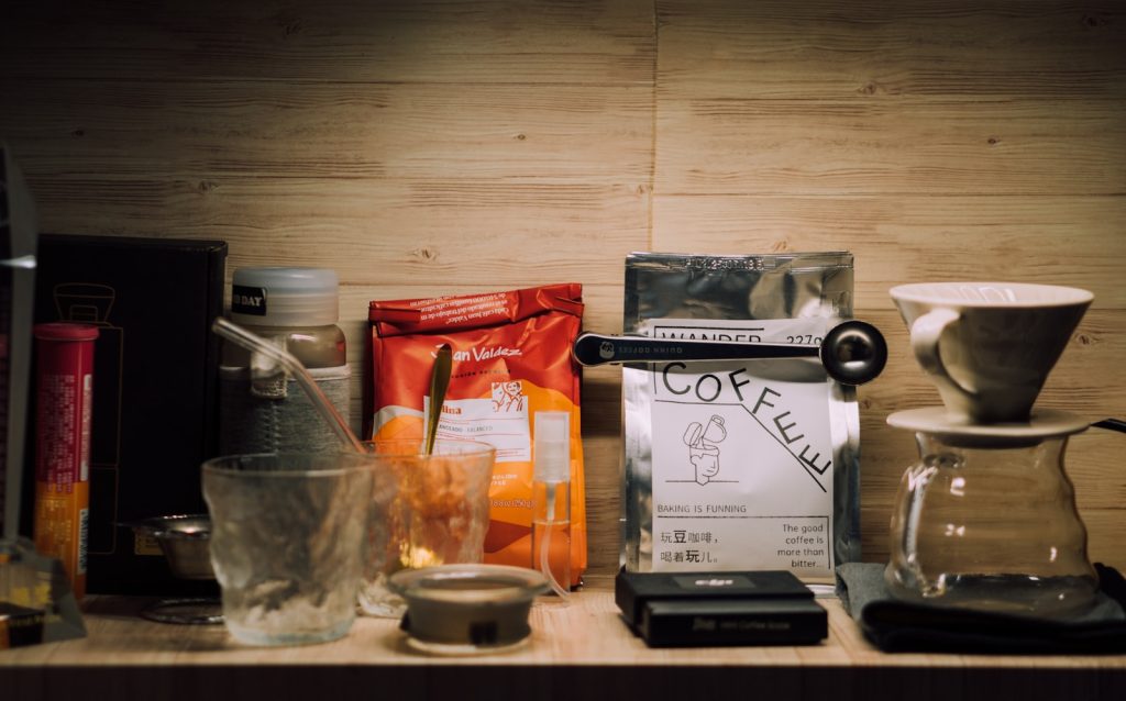 Coffee beans and brewing tools are arranged neatly.