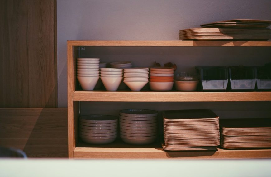 a shelf with bowls and plates on it