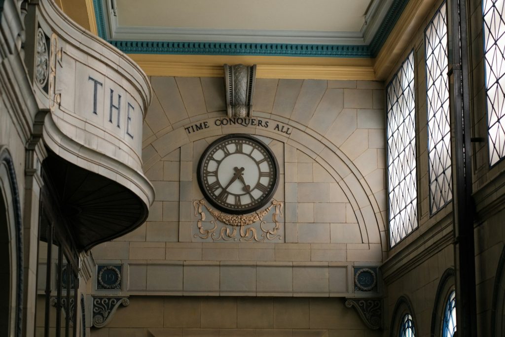 A large clock mounted to the side of a wall