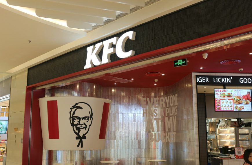 a kfc restaurant with a large sign above the entrance