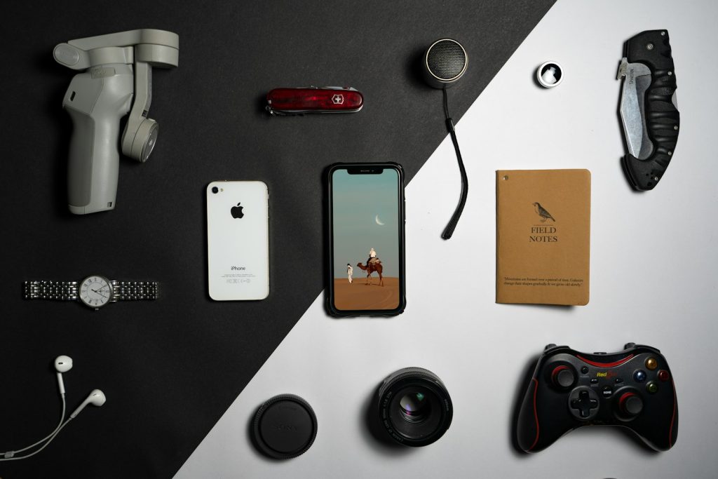 a collection of electronics and gadgets laid out on a table