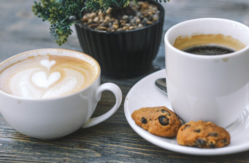 cup of black coffee and two cookies on saucer