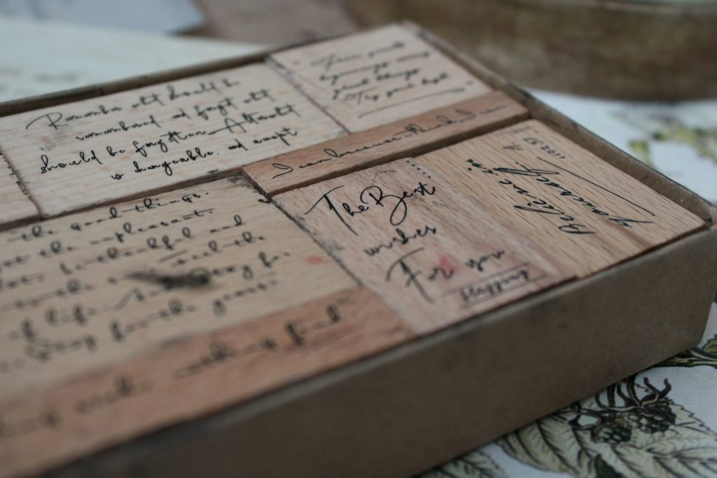 a wooden box with writing on it sitting on a table
