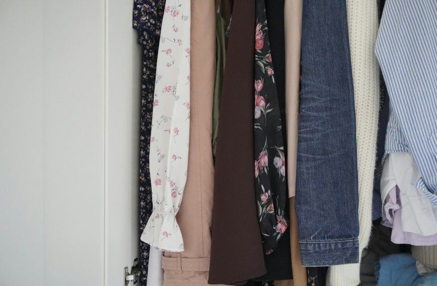 Assortment of clothes hanging in a closet