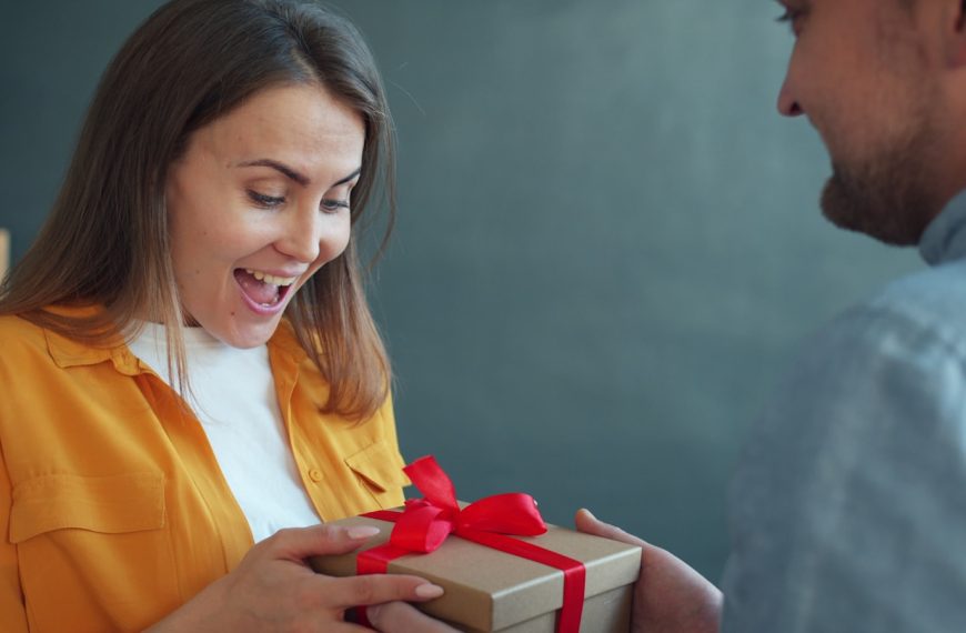 Woman happily receiving a gift from man