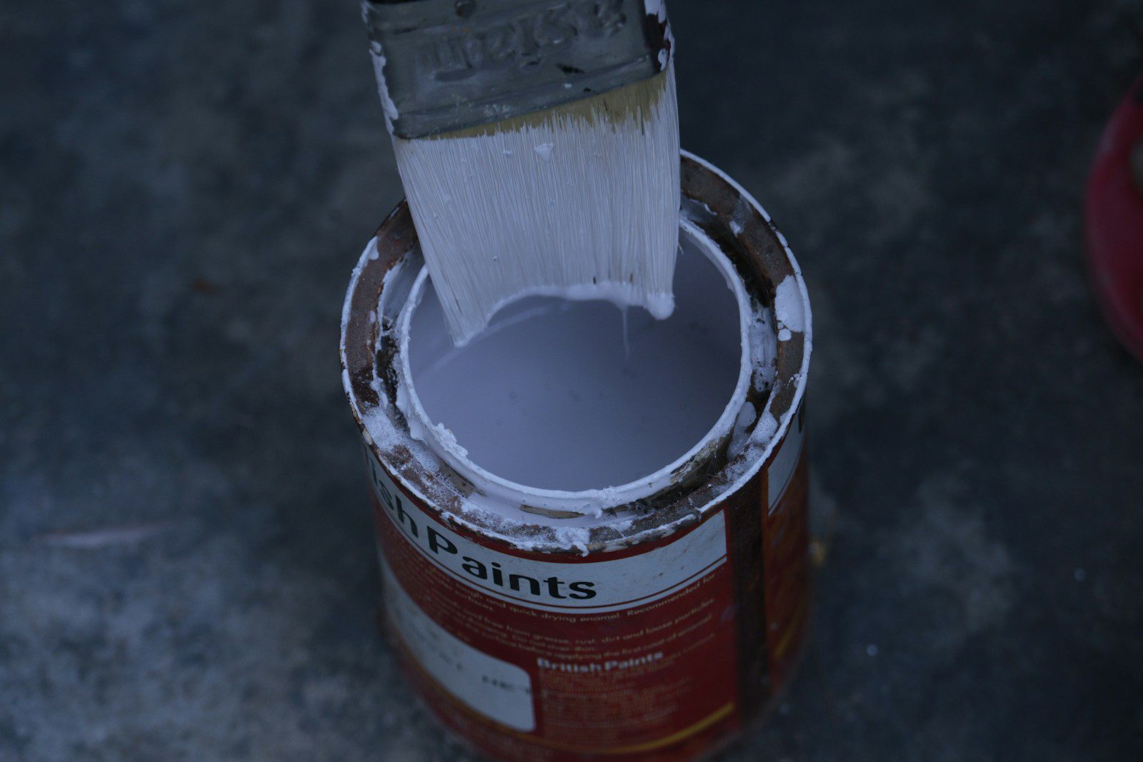 a paint can with a brush inside of it