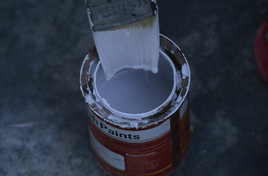 a paint can with a brush inside of it