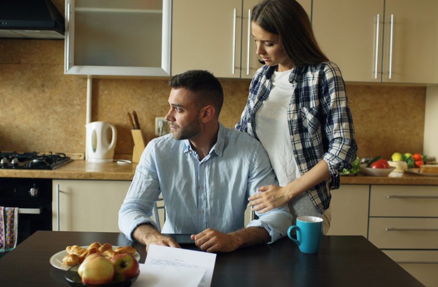 Couple sitting at kitchen table with pastries