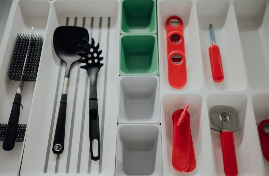 red handled spoon and fork on white plastic container